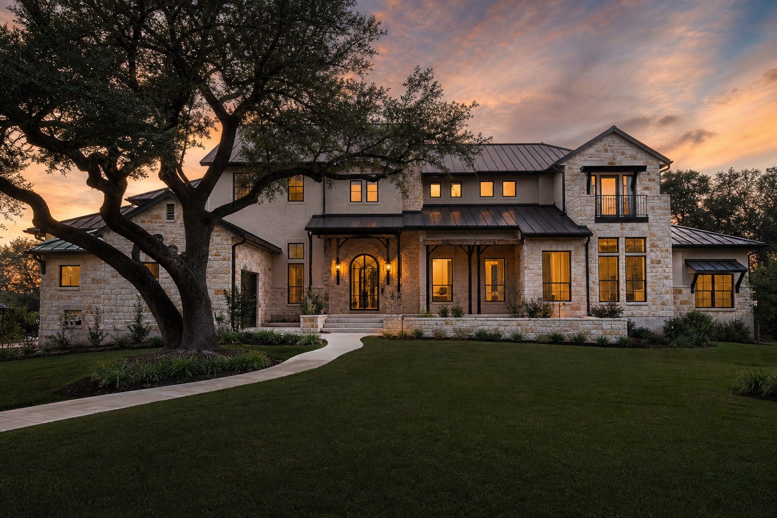 A stone and stucco San Antonio home under live oaks at dusk